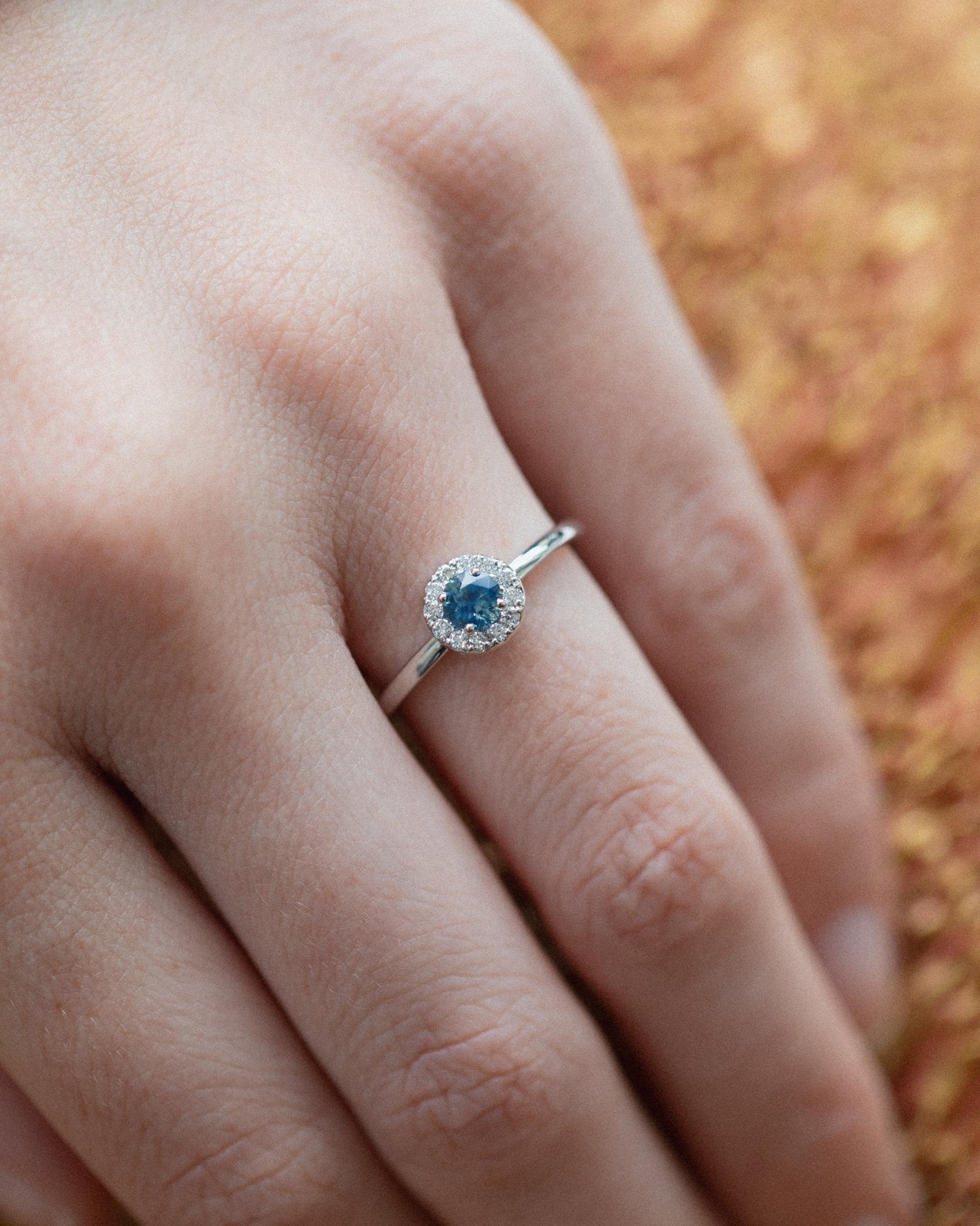 Round Halo Ring In Fairmined Gold with Montana Sapphire and Diamonds